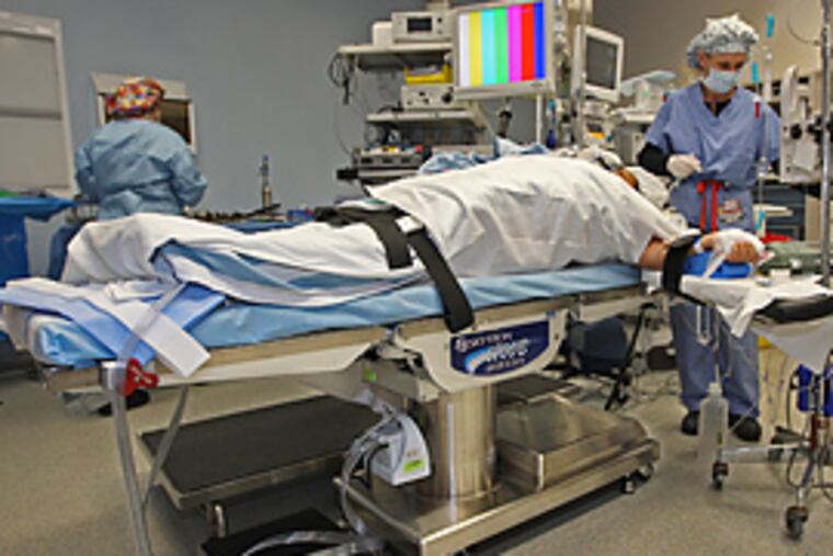 One of the newer, larger operating room tables that are made to take the extra weight the larger patients of Abington hospital might put on it. (Michael Bryant/Inquirer)
