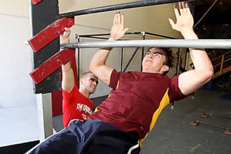 Chris Wilczewski watches Clarke Read go thru a drill. Profile of Warrior Lab and its founder, 23-year-old Chris Wilczewski, of Mount Laurel. He is teacher of Parkour and a fomer participant on the NBC show "American Ninja Warrior." Photos shot on Monday, July 2, 2012 at Warrior lab at 902 Park Ave., Hainesport,NJ. ( RON CORTES / STAFF PHOTOGRAPHER ).