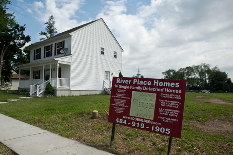 Still dealing with the fallout from the refinery closing, Marcus Hook is trying to get a failed housing development on track. It owns enough land to build 14 homes, but a previous developer backed out after constructing only three. A sign advertising the development stands next to one of the three homes at 203 Market St. (RON TARVER/Staff Photographer)
