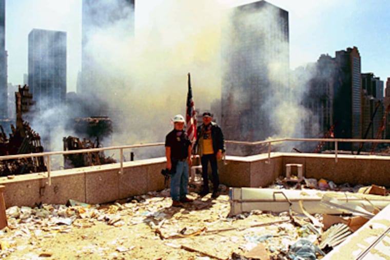 John Taggart and Michael Vincent, two members of the crime scene investigative team that the Philadelphia Police Department sent to ground zero, examine a rooftop at the disaster site. (Photo Courtesy Michael Vincent)