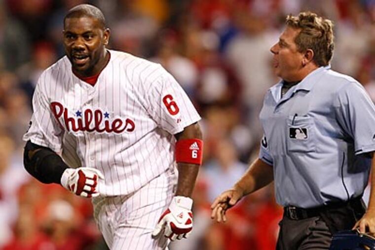 Greg Gibson and his fellow umpires were caught in controversy for the second straight night. (Ron Cortes/Staff Photographer)