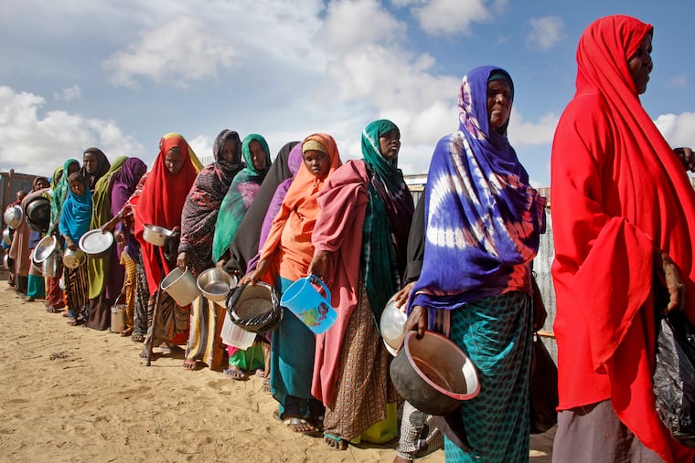 In this 2019 photo, citizens line up to receive food distributed by local volunteers at a camp for displaced persons near the Somali capital of Mogadishu.