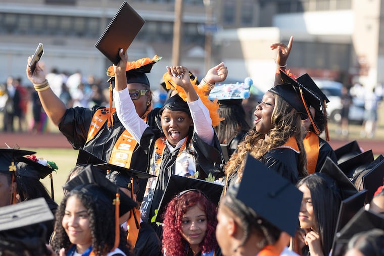 Racquel Carter, center, Davionna Ragin, right, and other students celebrate during the ceremony. Camden's Eastside High School graduated its last class on Tuesday, June 25, 2024. The nearly century old school will be demolished and replaced with a $105 million new building that will take five years to complete.