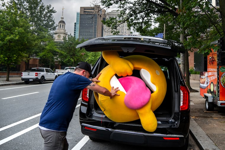 August 11, 2025: Chris Brown stows away Tongue, the mascot for a new hard iced tea brand, after wearing the lemon costume on a marketing stroll through the Historic District. Trenton-based Crooked Tea is a zero-sugar alcoholic tea brand founded by the creator of Bai, the antioxidant-infused coconut-flavored water, and launched in April with former Eagles defensive end Brandon Graham as a partner.