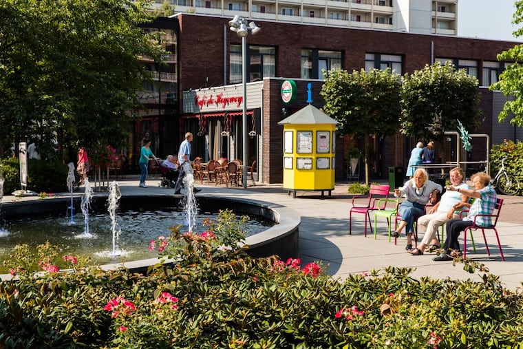 Residents enjoy a town square in the original dementia village, the Hogeweyk, in the Netherlands. It's an unusual nursing home designed like a village to make life feel as normal as possible for people with advanced dementia.