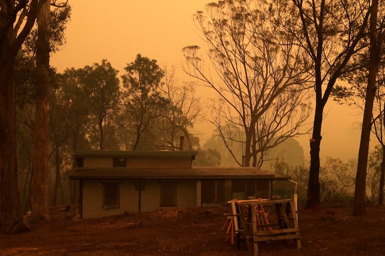 A mud brick house owned by Evan Harris where he is preparing to minimize fire impact at Burragate, Australia, last Friday as a nearby fire threatens the area.