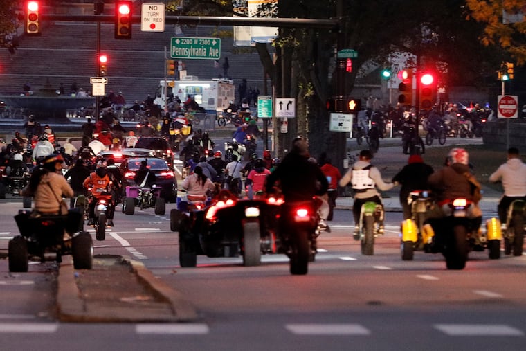 Hundreds of dirt bikes and ATV’s disregard the red lights as they race west on Spring Garden St. towards the Art Museum in Phila. on October 18, 2020.