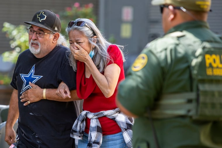 A woman cries Tuesday as she leaves the Uvalde Civic Center.