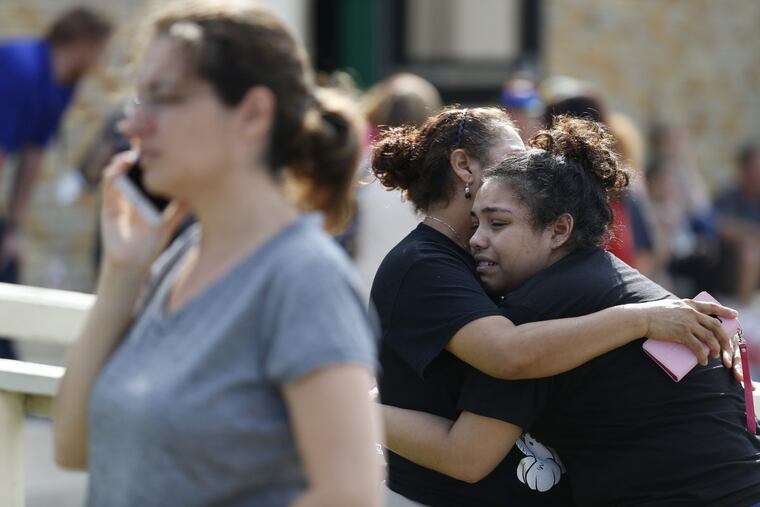 Santa Fe High School junior Guadalupe Sanchez, 16, cries in the arms of her mother, Elida Sanchez, following the mass shooting Friday that left 10 people dead.