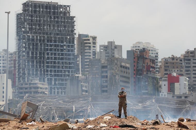 A soldier stands at the devastated site of the explosion in the port of Beirut, Lebanon, Thursday, Aug. 6, 2020. French President Emmanuel Macron came in Beirut to offer French support to Lebanon after the deadly port blast.