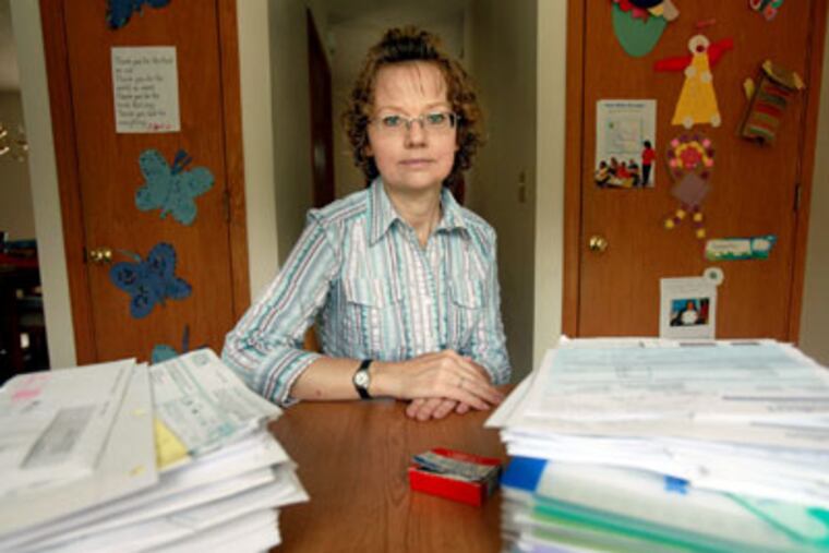 Sara Goins, of Milwaukee, pictured September 21, 2009 with her policy information, hit her lifetime maximum of insurance after being diagnosed with leukemia two years ago. (Kristyna Wentz-Graff / Milwaukee Journal Sentinel / MCT)