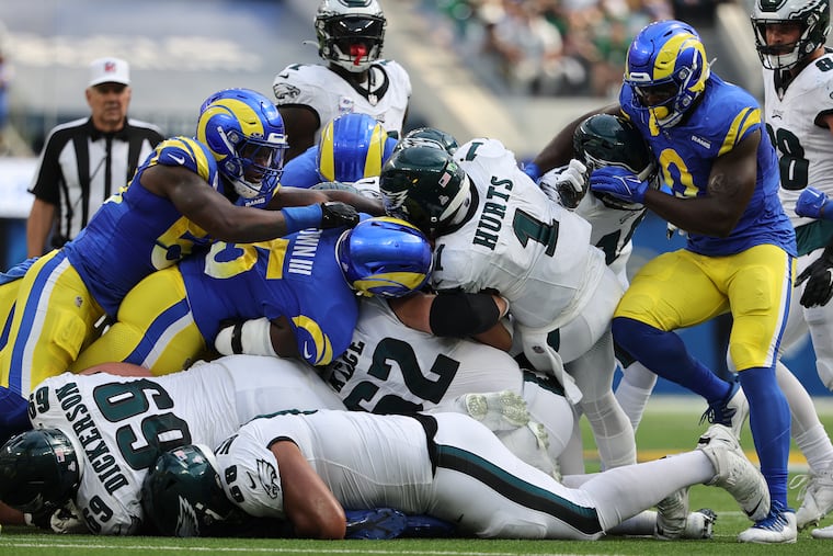 Eagles quarterback Jalen Hurts sneaks for a first down past the Los Angeles Rams defense in the second quarter at SoFi Stadium.