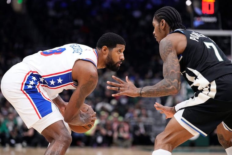 Paul George stares off against Milwaukee Bucks guard Kevin Porter Jr. at Fiserv Forum on Friday.