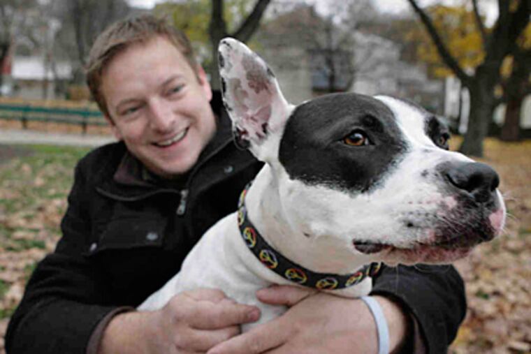 Garrett Elwood and his mixed-breed dog, Vegas, at Manayunk's Pretzel Park. (Elizabeth Robertson/Staff)