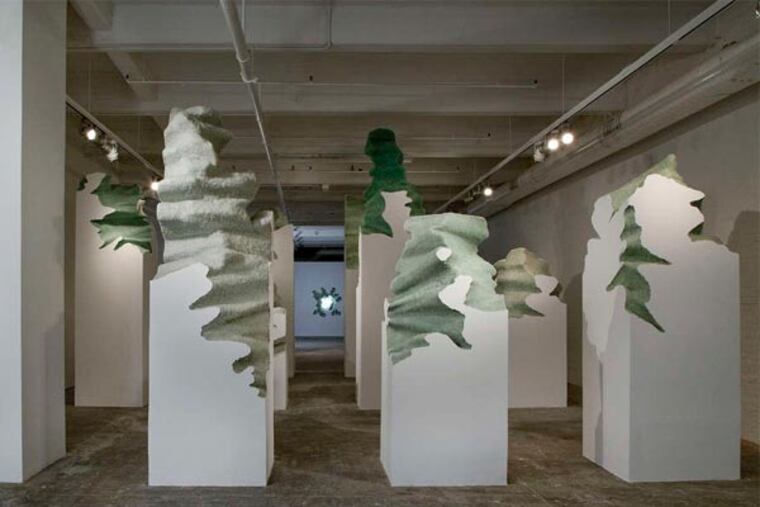 Daniel Arsham's "Columns," front, evoke his theme of architectural destruction informed by his experience of Hurricane Andrew in 1992. At rear is "Storm," a wall cavity with a motion sensor that triggers storm sounds and bursts of light.