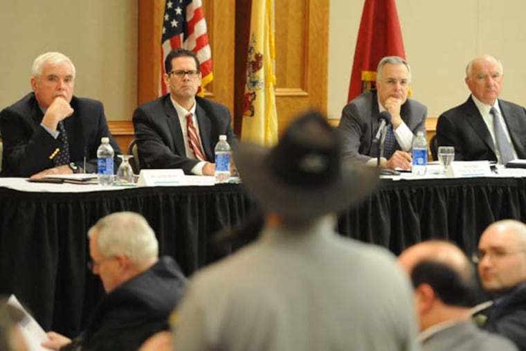 Four of the six members of Governor Christie's NJ SAFE Task Force -- (from left) James Romer, Dr. Manuel Guantez, Peter G. Verniero and John J. Degnan -- listen to John Snively, Mullica Hill, speak during the meeting Tuesday night, Feb. 5, 2013, at Rugers Camden. ( CLEM MURRAY / Staff Photographer )