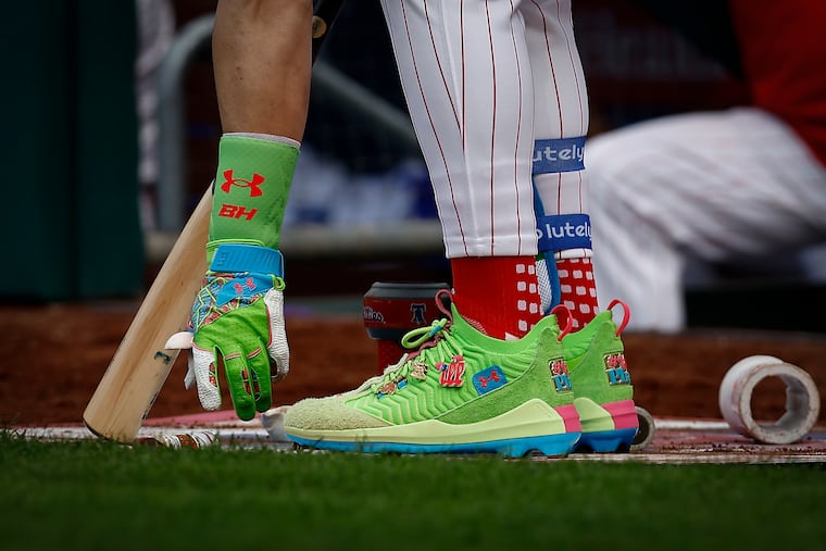 Phillies first baseman Bryce Harper readies himself on the on deck circle in his new custom Under Armour cleats during the team's home opener against the Colorado Rockies.