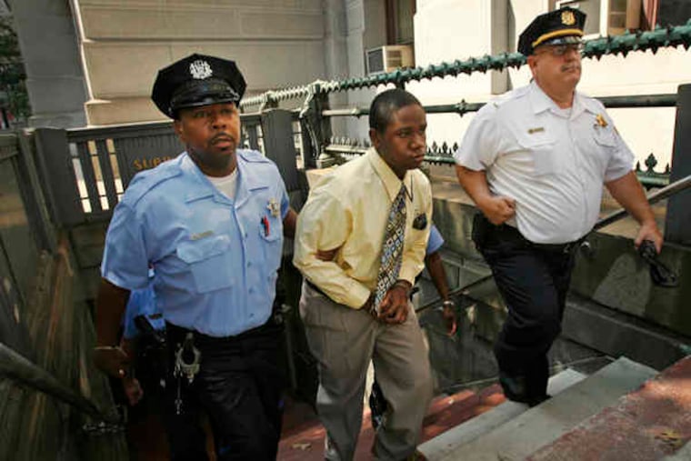 Sheriff's deputies escort defendant Kinta Stanton from the 13th Street subway station, where Sean Patrick Conroy was beaten last year. Jurors, lawyers, and others toured the scene yesterday.