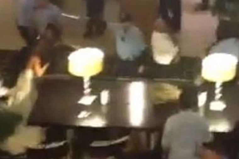 A still image from a video posted to YouTube shows the melee that erupted at the Society Hill Sheraton on Sunday among the attendees of two weddings. Three people were arrested and one man died of a heart attack.