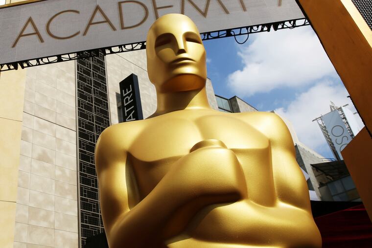 In this Feb. 21, 2015 photo, an Oscar statue appears outside the Dolby Theatre for the 87th Academy Awards in Los Angeles.