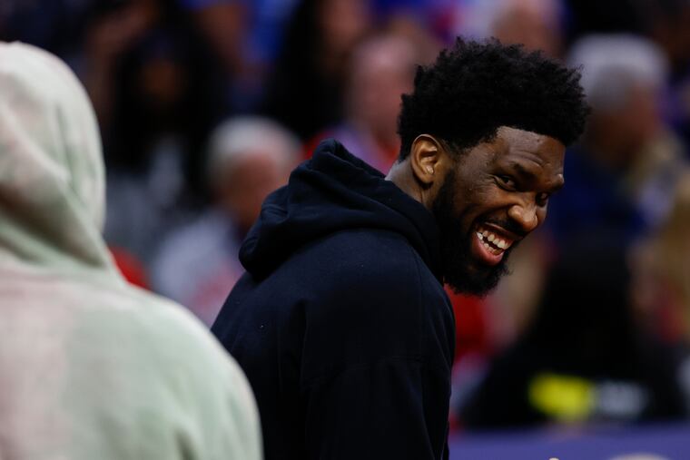 Sixers center Joel Embiid laughs during a second quarter break against the Detroit Pistons in April.