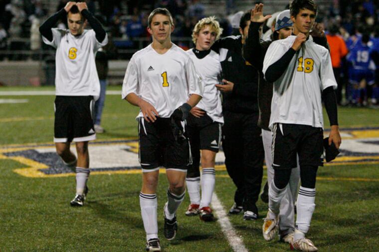 Moorestown players (from left) Chris O'Donnell, Brendan Conrey, Brooks Foster and John Stalle leave the field.
