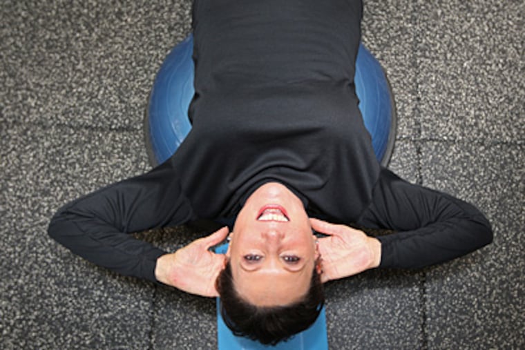 Cindy Shaffran does stomach crunches lying on a soft plastic dome at Zarett's, whose fitness clientele has grown to about 500 in the last three years. (Michael Bryant / Staff Photographer)