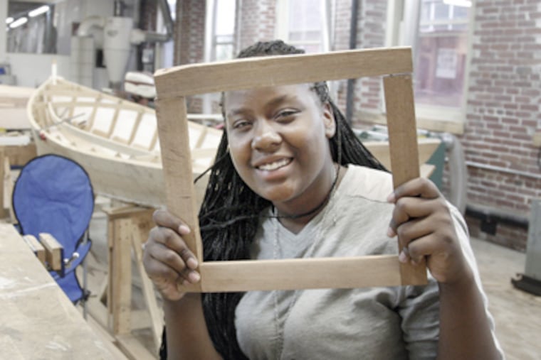 Alisha Rothwell, 14, made this picture frame during down time at the Wooden Boat Factory. (Elizabeth Robertson / Staff Photographer)