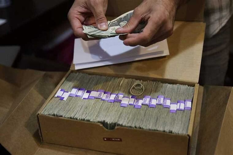 The owner of a medical marijuana dispensary in Los Angeles prepares his monthly tax payment. Marijuana businesses may become even more dependent on cash thanks to recent action from Attorney General Jeff Sessions.