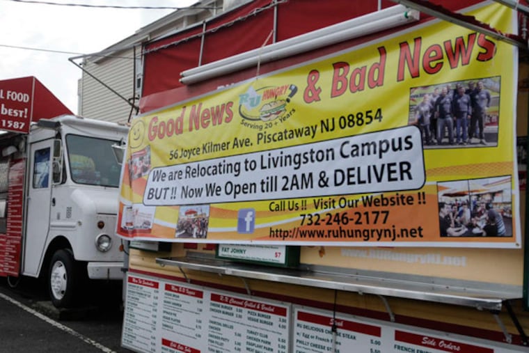 A sign on the RU Hungry? truck at Rutgers New Brunswick's Parking Lot 8 says where it's moving. The land will house a 500-bed student residence with retail space, a public lawn with a huge screen, and Boardwalk-like food concessions. (Ron Tarver / Staff Photographer)