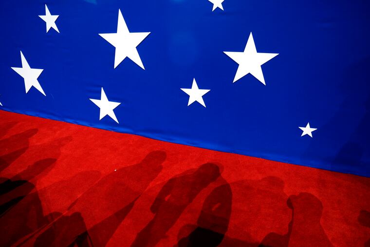 In this July 2016 photo, the shadows of delegates are seen on the convention floor during the second day of the Republican National Convention in Cleveland.