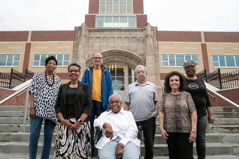 From left, Barbara Fisher Richardson, Delia Ford Brown, Ira Back, A. Dolores Rozier, Ron Venella, Dolores Firth Bailey and Shirley Edwards Tompkins, all of the Camden High School Class of 1960, in front of Camden High School on Tuesday. The class will hold its 60th reunion this weekend, a year late due to the pandemic.