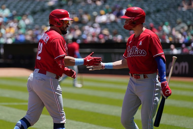 Kyle Schwarber, left, is congratulated by Trea Turner after hitting a home run during the first inning.
