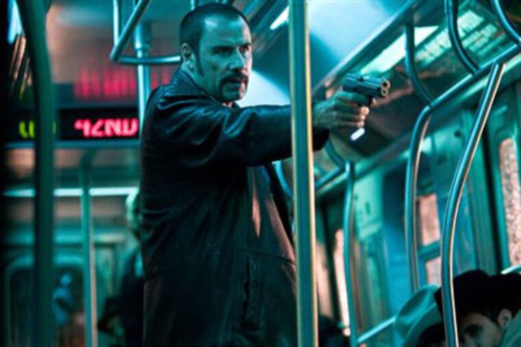 John Travolta as Ryder, the leader of a band of bad guys that seizes a
New York subway car and takes the passengers hostage.