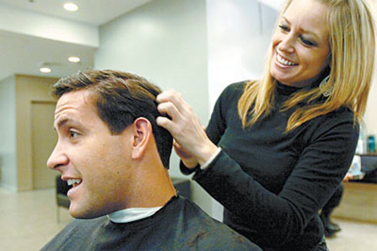 Richard Whiting, 28, with stylist Ellen Dzik at Style of Man, Shops at Liberty Place. (Clem Murray / Staff Photographer)
