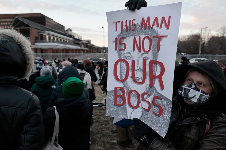 Matt Dunphy holds a picture of Elon Musk during the Save Our Services day of action event at Independence Mall on Wednesday. The crowd was there to protest the Trump administration's push to gut federal services and impose mass layoffs.