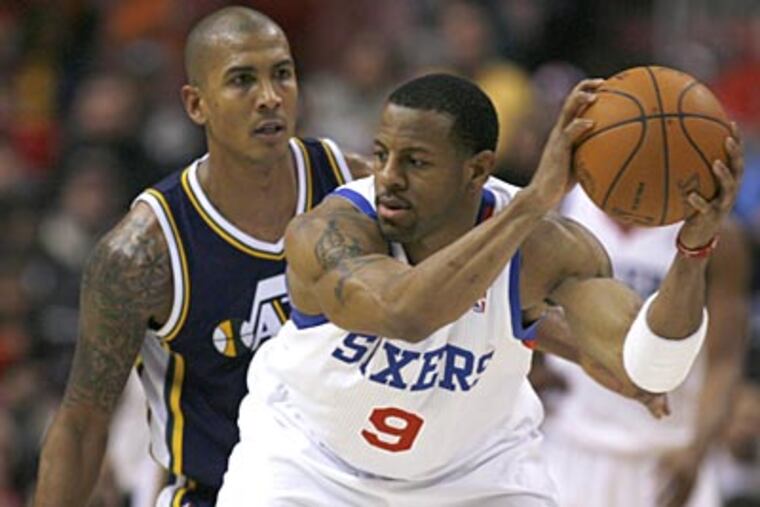 Andre Iguodala keeps the ball away from Raja Bell during the Sixers' 96-85 win over the Jazz. (H. Rumph Jr./AP Photo)