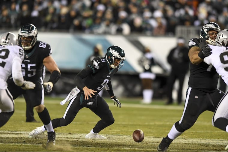 Eagles quarterback Nick Foles fumbles the ball on the snap from center in the 2nd quarter of the game at Lincoln Financial Field December 25, 2017. Foles recovered the ball. CLEM MURRAY / Staff Photographer