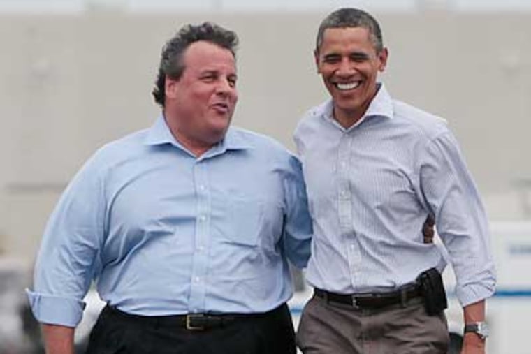 President Barack Obama walks with New Jersey Gov. Chris Christie in Newark, N.J., as they returned from Paterson, N.J., after viewing damage caused by Hurricane Irene, Sunday, Sept. 4, 2011. (AP Photo/Charles Dharapak)