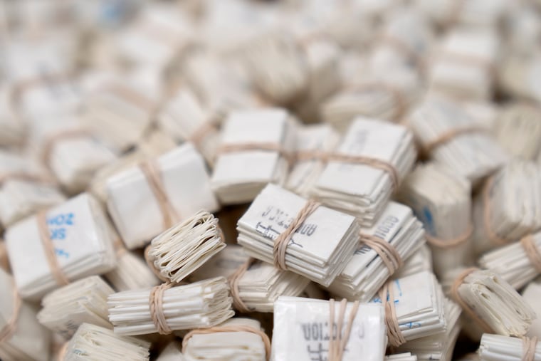 Glassine envelopes used to package fentanyl pills and fentanyl powder are displayed at a DEA research laboratory in Virginia. China's crackdown may have had a role in reducing U.S. overdose deaths.