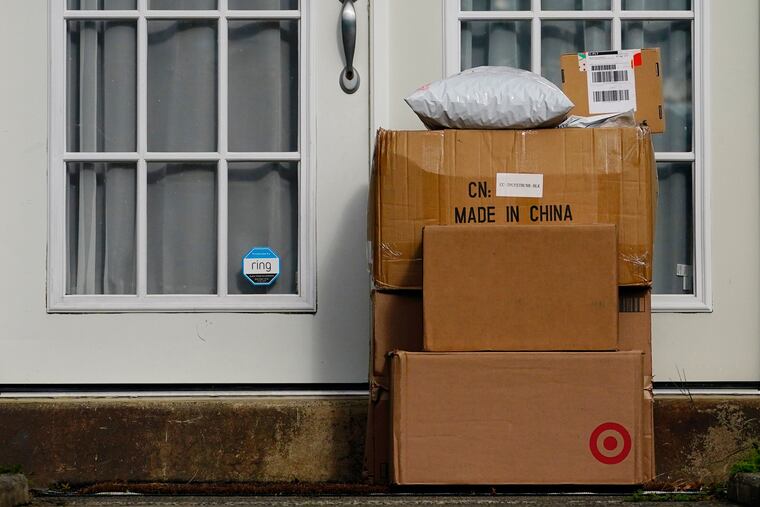 Packages are seen stacked on the doorstep of a residence in Upper Darby, Pa., in October 2021.
