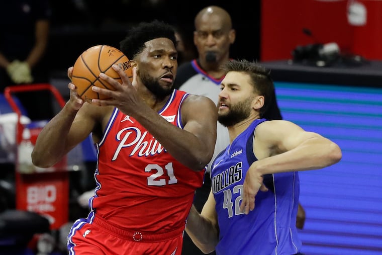 Sixers center Joel Embiid driving to the basket against Dallas Mavericks forward Maxi Kleber on Thursday.