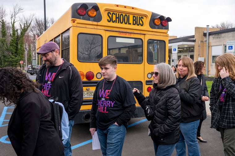 Cherry Hill High School East junior Jack Neary (center) boards a school bus with his parents Jim Neary (left) and Laurie Neary (right) joining other students, teachers and board members to attend a public hearing on Gov. Murphy's proposed budget.