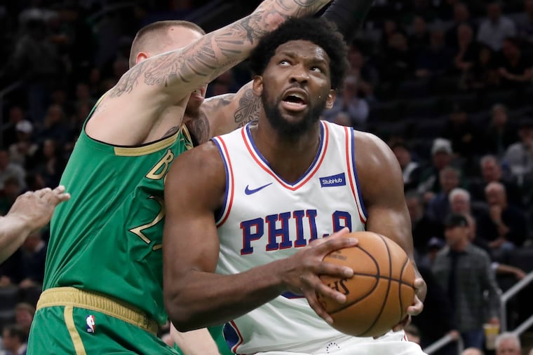 Philadelphia 76ers center Joel Embiid looks for room to shoot against Boston Celtics forward Daniel Theis, left, in the first quarter of an NBA basketball game, Thursday, Dec. 12, 2019, in Boston. (AP Photo/Elise Amendola)