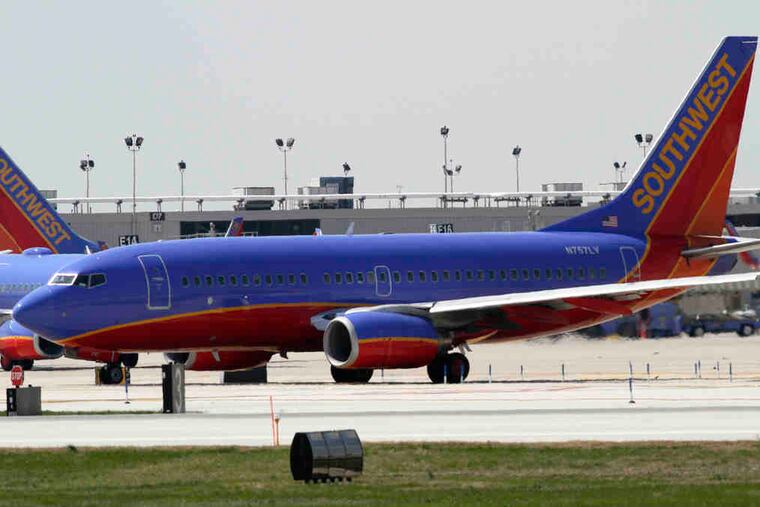 A Southwest Airlines jet taxis at Philadelphia International Airport. While Southwest managed a small first-quarter profit, United and American Airlines posted losses.