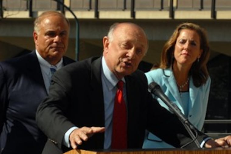 With Gov. Ed Rendell standing behind him, former CIA Director R. James Woolsey Jr. delivers a pitch for energy independence and biofuels at a news conference at Independence National Park's Visitors Center.