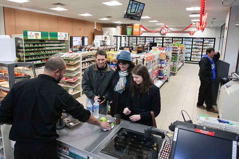 7-Elevens are popping up all over Center City as part of a plan to get urban customers. A new 7-Eleven opened Thursday at 10th and Filbert streets, where Emmanuel Ortiz (above) works the counter on opening day.