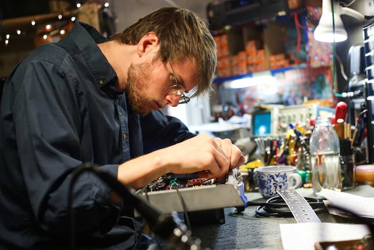 Rootbeer Audio's Matt Manhire working on an amp in his workshop in Fishtown. (ANDREW THAYER / Staff Photographer)