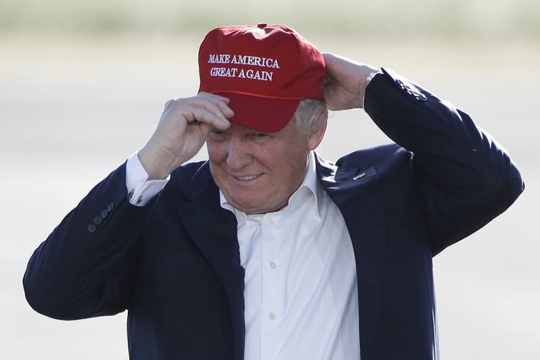 In this June 1, 2016, file photo, Republican presidential candidate Donald Trump wears his "Make America Great Again" hat at a rally in Sacramento, Calif.
