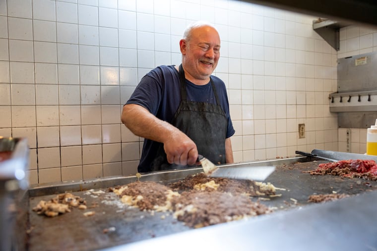 Paul Castellucci Sr. makes cheesesteaks for pickup orders at his restaurant, Mama’s Pizzeria, in March.